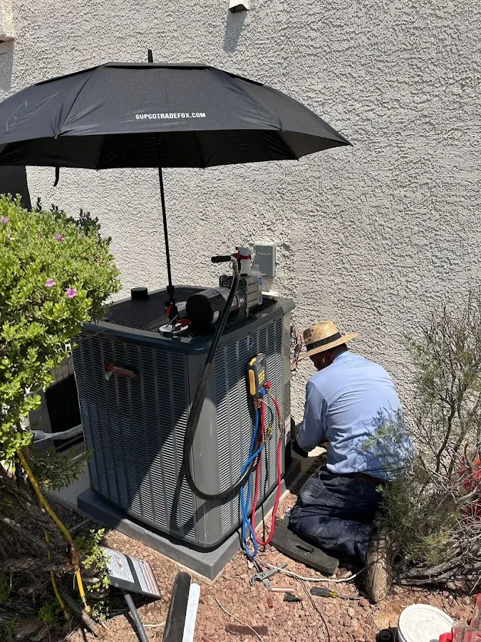 HVAC technician performing outdoor AC maintenance in Bee Ridge